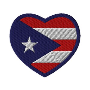 May include: Embroidered heart-shaped patch featuring the flag of Puerto Rico. The design includes a blue field with a white star, and alternating red and white stripes. The patch is suitable for clothing or accessories.