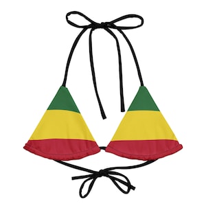 May include: A triangle bikini top with a color scheme of green, yellow, and red, with black ties. The top features a vibrant design, perfect for beach or pool wear. The bikini top is a stylish and eye-catching piece.