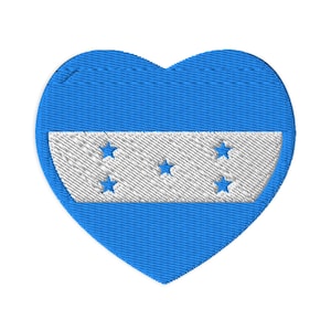May include: A blue heart-shaped patch with a white stripe and five blue stars. The patch is a representation of the Honduran flag.