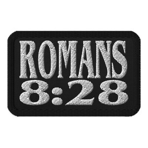 May include: Black embroidered patch with white text that reads "Romans 8:28".