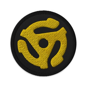 May include: A black and yellow embroidered patch with a stylized record player symbol.