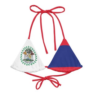 May include: A two-piece bikini top featuring the flag of Belize. The top has red ties and a triangle design. One triangle is white with the Belize coat of arms, and the other is blue with a red border.