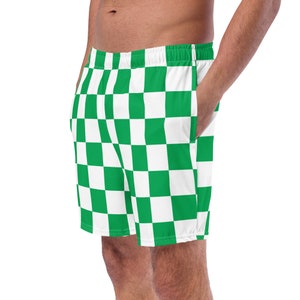 Könnte beinhalten: Grün-weiß karierte Badeshorts. Die Shorts haben einen elastischen Bund und Taschen. Das Muster ist ein sich wiederholendes Raster aus grünen und weißen Quadraten. Die Shorts sind aus leichtem Material.
