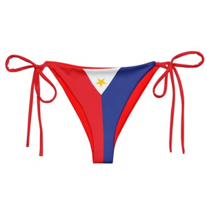 May include: Red, white, and blue bikini bottom with a yellow star in the center. The bikini bottom is made of a stretchy fabric and has adjustable ties.