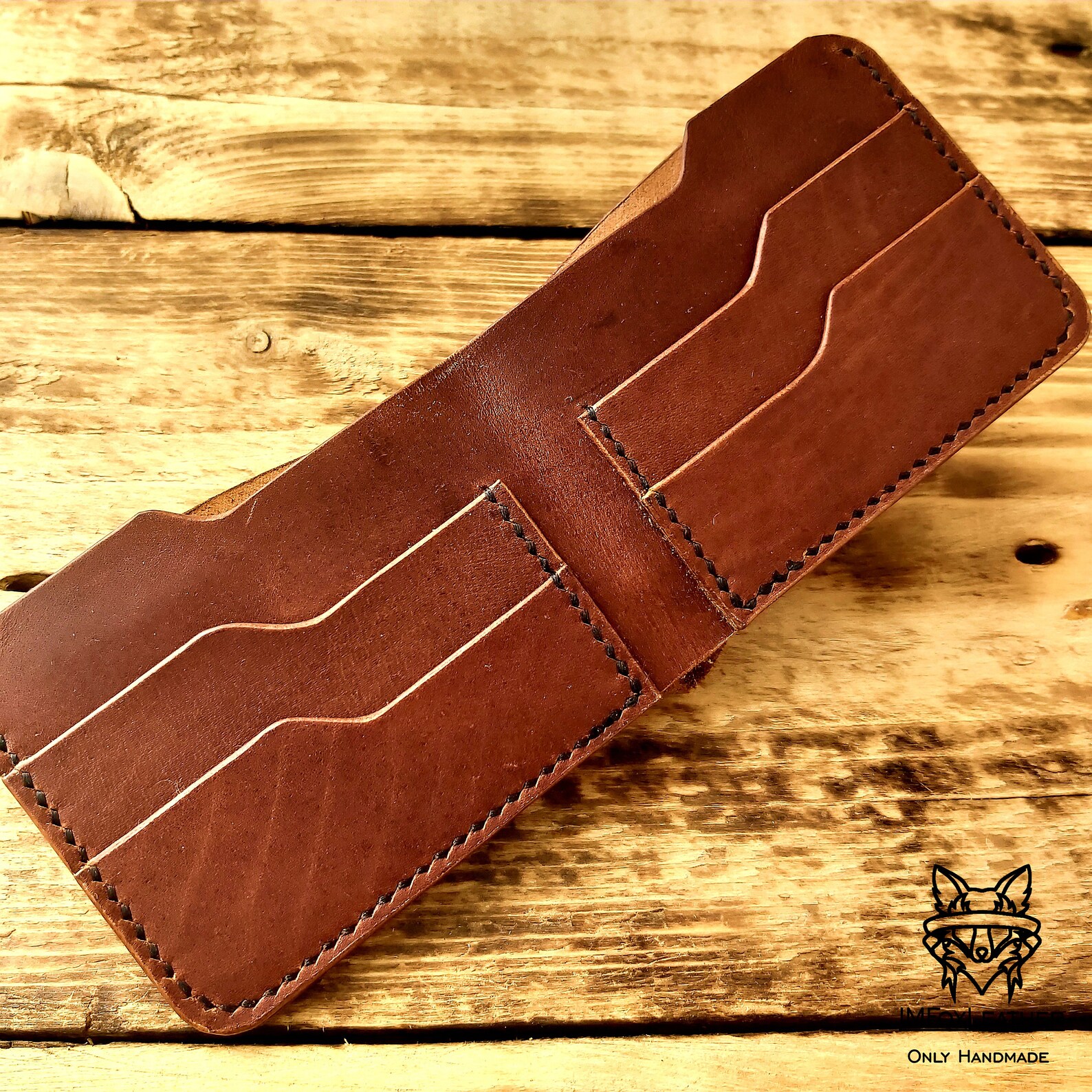 Handmade leather bifold wallet with laser engraving of the Etsy