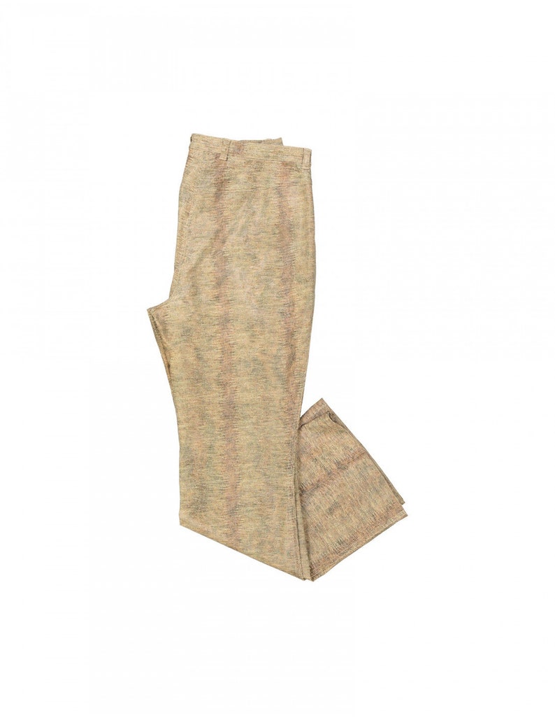 May include: Tan-colored pants with a textured weave. The pants have a straight leg design and a neutral color palette, suitable for various outfits. The fabric appears to have subtle variations in color, adding visual interest to the garment.