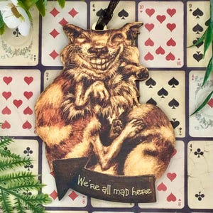 Alice in Wonderland Cheshire Cat pink fantasy hanging decoration. Wonderfully weird vintage style Christmas tree ornament decor.
