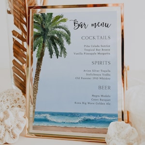 May include: A framed bar menu with a watercolor illustration of a palm tree and ocean waves. The menu lists cocktails, spirits, and beers. The text on the menu reads: "Bar menu", "Cocktails", "Piña Colada Sunrise", "Tropical Bay Breeze", "Vanilla Pineapple Margarita", "Spirits", "Avion Silver Tequila", "Stolichnaya Vodka", "Old Forester 1910 Whiskey", "Beer", "Negra Modelo", "Coors Banquet", "Kona Big Wave Golden Ale".