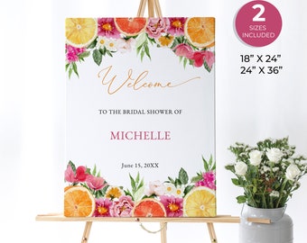 May include: A welcome sign for a bridal shower with a floral and citrus design. The sign is white with gold lettering and says "Welcome to the bridal shower of Michelle June 15, 20XX". The sign is 18 inches by 24 inches or 24 inches by 36 inches.