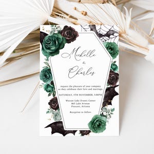 May include: A wedding invitation with a gothic theme. The invitation features a black and green floral design with bats and a spiderweb. The text on the invitation reads "Michelle & Charles" and includes the date, time, and location of the wedding.