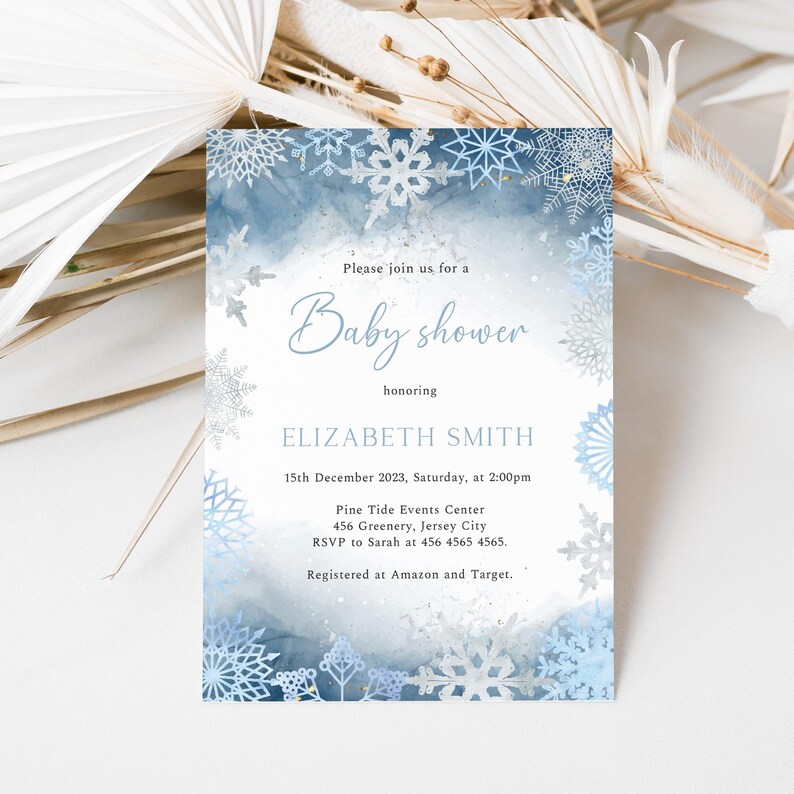 May include: Baby shower invitation with a winter theme. The invitation features a watercolor background in shades of blue and white, with snowflake accents. The text reads "Please join us for a Baby shower honoring Elizabeth Smith."
