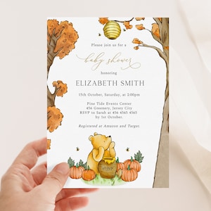 May include: A baby shower invitation featuring a watercolor illustration of Winnie the Pooh with pumpkins, a honey pot, and a beehive. The invitation includes the text "baby shower" and details for Elizabeth Smith's shower.