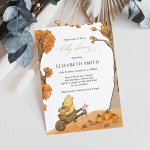 May include: Baby shower invitation featuring a watercolor illustration of Winnie the Pooh and Piglet with pumpkins. The invitation includes the text "Please join us for a baby shower honoring Elizabeth Smith" and event details.