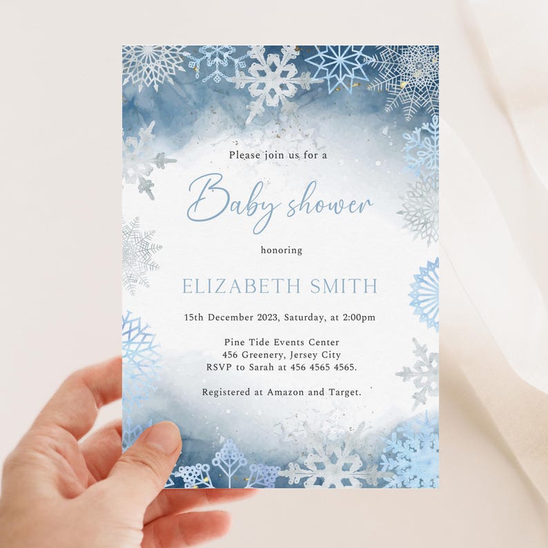May include: A baby shower invitation with a winter theme. The invitation features a watercolor background in shades of blue and white, with snowflake accents. The text reads "Baby shower" and includes event details.