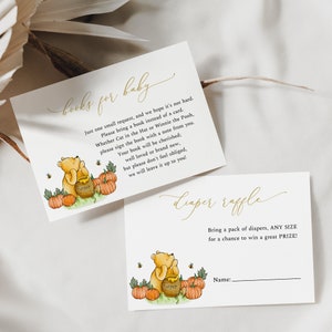 May include: Two baby shower invitation cards. One card reads "Books for Baby" with a Winnie the Pooh illustration. The other card reads "Diaper Raffle". Both cards have gold script and illustrations of pumpkins and bees.