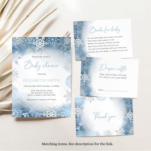 May include: Baby shower invitation set with a snowflake design. The invitation includes details for Elizabeth Smith's baby shower on December 15th, 2023, at 2:00 pm. Additional cards include requests for books and a diaper raffle. The set has a blue and white watercolor design.