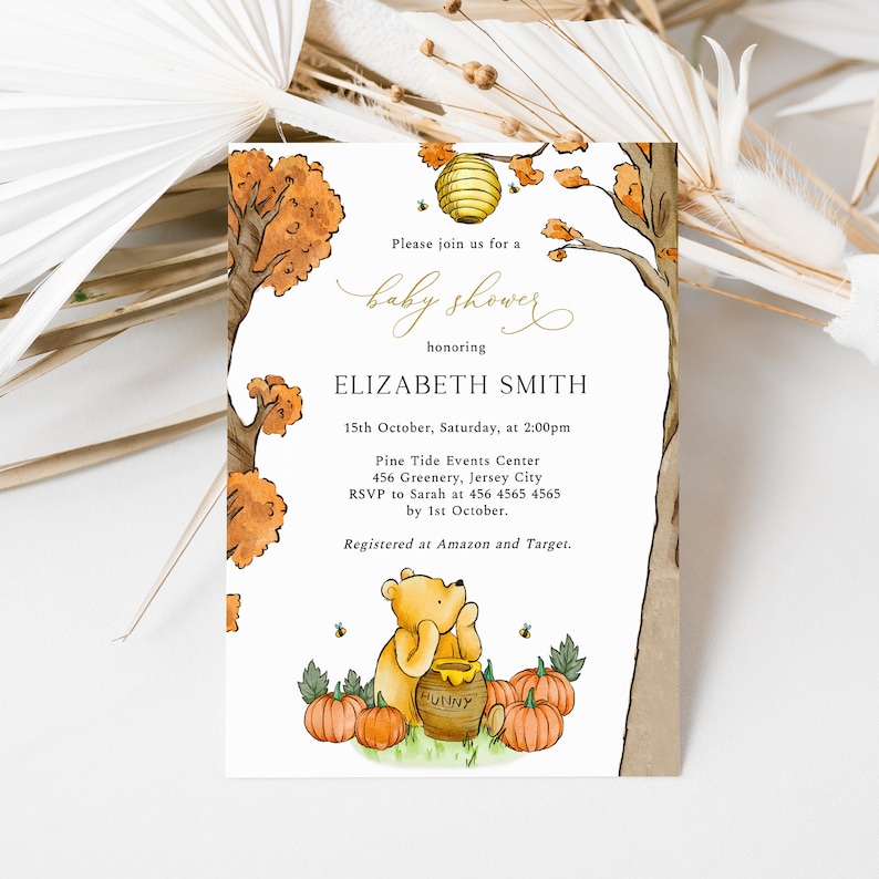 May include: Baby shower invitation featuring a watercolor illustration of Winnie the Pooh with pumpkins and a honey pot. The invitation includes the text "Please join us for a baby shower honoring ELIZABETH SMITH". The date and time are also included.
