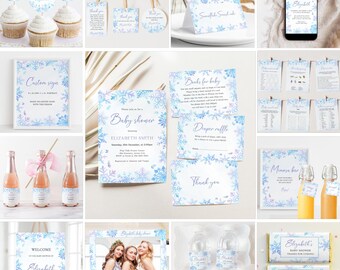 Op de afbeelding: Een verzameling baby shower decoraties met een winterthema. Items zijn onder meer uitnodigingen, borden, cupcake toppers, waterfles labels en candy bar wrappers. De ontwerpen bevatten blauwe en paarse sneeuwvlokken.
