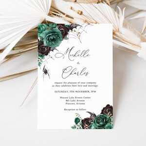May include: A wedding invitation with a gothic theme. The invitation features a black spider, a spider web, and dark green and burgundy roses. The text on the invitation reads "Michelle & Charles request the pleasure of your company as they celebrate their love and marriage. Saturday, 5th November, 5PM Watson Lake Events Center 865 Lake Avenue Prescott, Arizona Reception to follow."