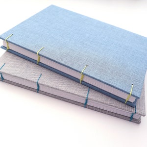 two handmade coptic bookbindings made using the papercraftpanda coptic bookbinding materials kit