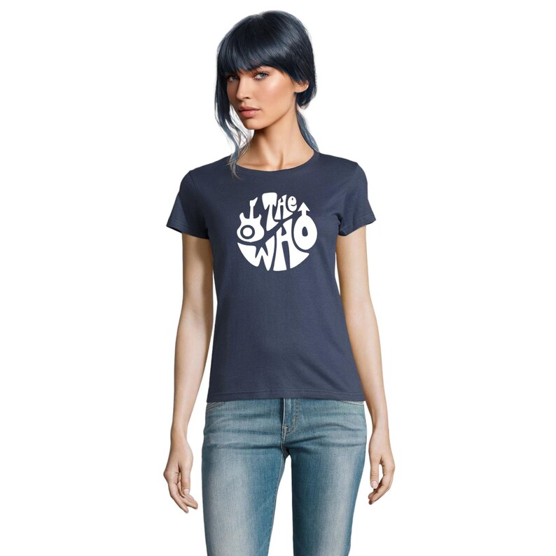 May include: A navy blue t-shirt with a white circular design featuring the text "The Who" and a guitar illustration. The short-sleeved top is made of a soft material, suitable for casual wear.