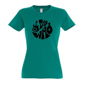 May include: Teal t-shirt with a black circular design featuring the words "The Who", a guitar, and a male symbol. The top has short sleeves and a crew neck.