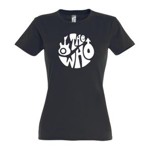 May include: Black t-shirt with a white circular design featuring the band name "The Who" and various symbols. The shirt has short sleeves and a crew neck. The design includes a guitar and other symbols.
