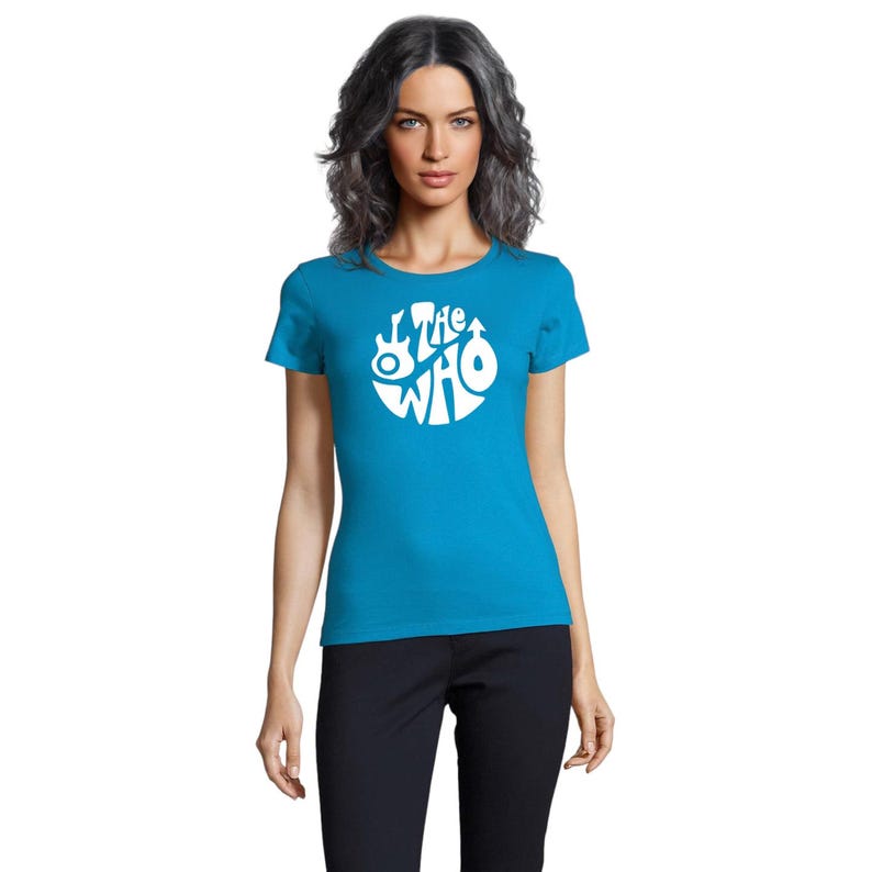 May include: A turquoise blue t-shirt with a white circular graphic featuring the text "The Who" and musical instrument illustrations. The shirt has short sleeves and a crew neck.