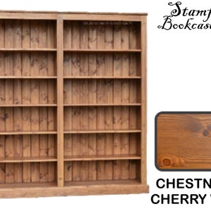 May include: A large wooden bookcase with multiple shelves. The bookcase is constructed from vertical wooden planks and has a warm chestnut and cherry wax finish. The text "Stamford Bookcase Co" is visible.