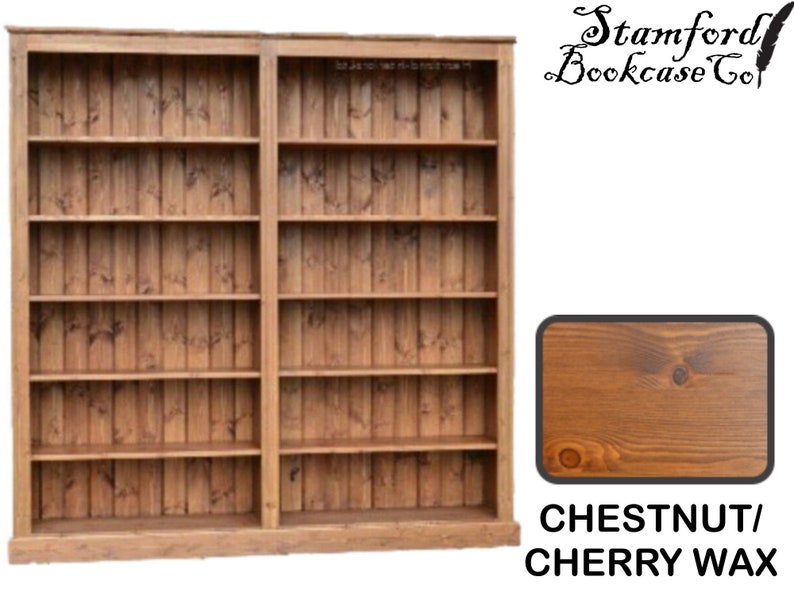May include: A large wooden bookcase with multiple shelves. The bookcase is constructed from vertical wooden planks and has a warm chestnut and cherry wax finish. The text "Stamford Bookcase Co" is visible.
