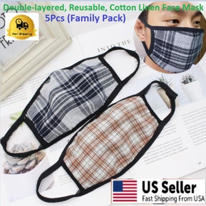 May include: Five pack of double-layered, reusable cotton linen face masks. The masks have a plaid pattern in black, white, and brown. The masks are shown on a white surface.