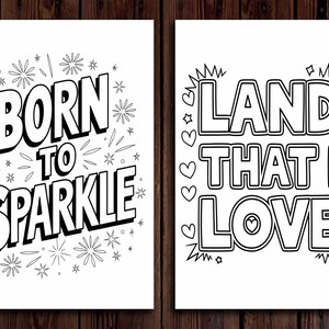 May include: Two black and white art prints with inspirational quotes. The first print says "BORN TO SPARKLE" with starburst and star illustrations. The second print says "LAND THAT I LOVE" with heart and star illustrations.