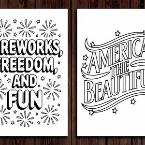 May include: Two black and white prints with patriotic themes. One print reads "Fireworks, Freedom, and Fun" with star and firework illustrations. The other print says "America the Beautiful" with star and wave illustrations.