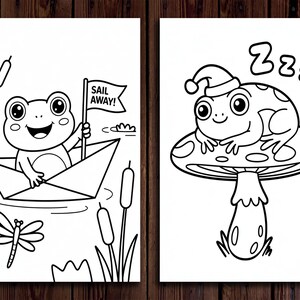 May include: Two black and white illustrations of frogs. One frog is in a paper boat holding a flag that says "Sail Away!". The other frog is wearing a hat and sleeping on a mushroom. The background is a wooden surface.