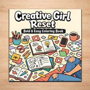 May include: A coloring book titled "Creative Girl Reset" with the subtitle "Bold & Easy Coloring Book." The cover features a colorful illustration of open books, pencils, scissors, and a coffee cup, suggesting a creative theme.