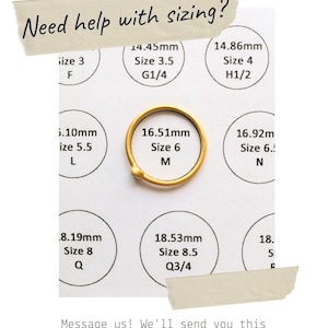 May include: A printable size chart for rings, with a gold ring in the center. The chart shows different ring sizes in millimeters and corresponding letter sizes. The text "Need help with sizing?" is at the top of the chart.