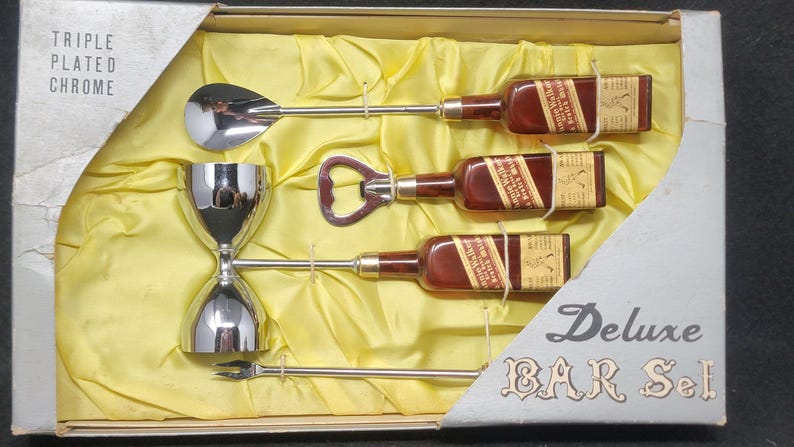 May include: A vintage chrome bar set in a box with the words "Triple Plated Chrome" and "Deluxe Bar Set". The set includes a jigger, a bottle opener, a spoon, and three miniature liquor bottles.