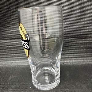 May include: A white ceramic mug with a black handle and the text "But first, coffee" in a handwritten style. The mug is on a white surface. The mug is approximately 4 inches tall.