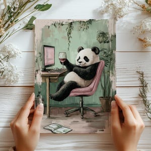 May include: A panda bear sitting at a desk with a glass of wine, a computer, and a notebook. The panda is wearing a pink chair and is surrounded by plants.