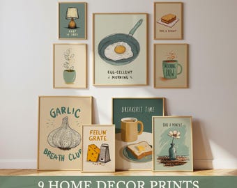 May include: Nine framed art prints with a breakfast theme. The prints feature illustrations of a fried egg, garlic, a biscuit, a coffee mug, and a flower. Text includes "Keep it Cozy", "Egg-cellent Morning", and "Breakfast Time".