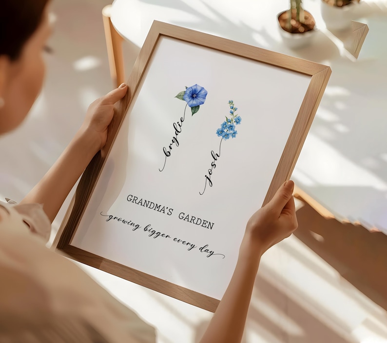 May include: A framed print with a watercolor illustration of two blue flowers. The text "Grandma's Garden growing bigger every day" is written below the flowers. The names "Brydie" and "Josh" are written in cursive above the flowers.