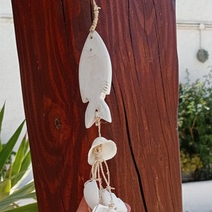 White fish and seashells hanging outdoor art decoration