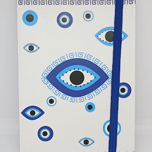 Cuaderno mal de ojo blanco o azul