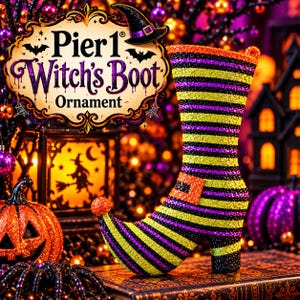May include: A glittery witch's boot ornament featuring horizontal stripes in yellow, purple, and black. The boot has a curled toe with a small orange pom-pom and a buckle detail. Text on the image reads Pier 1 Witch's Boot Ornament.