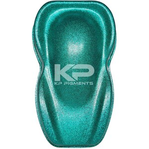 May include: A teal green metallic paint sample with a glittery finish. The sample is shaped like a car and has the text "KP Pigments" printed on it.