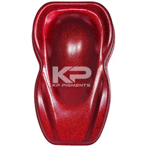 May include: A red glitter paint sample with a glossy finish. The sample is shaped like a teardrop and has the text "KP PIGMENTS" printed on it.