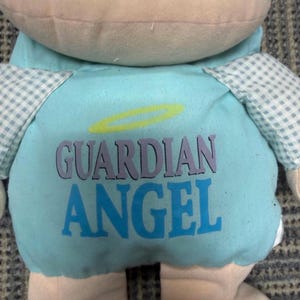 May include: A white ceramic mug with a black handle and the text "But First, Coffee" in a black, bold font. The mug is on a white surface. The mug is approximately 4 inches tall.