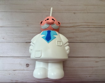 Dr. Simi Water Bottle – Botella de Agua, Famous Mexican Doll, Accesorio Kitsch, Concert Collectible, Muñeco Mexicano