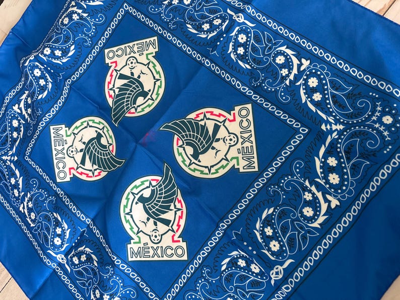 May include: A vibrant blue bandana featuring the Mexican national emblem repeated four times. The emblem includes a stylized eagle, a soccer ball, and the word "MEXICO". The border has a white paisley design.