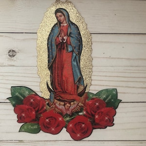 May include: A gold glitter cutout of the Virgin Mary with a blue robe and red dress, surrounded by red roses with green leaves and gold glitter accents. The image includes the text "Cecil".